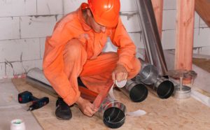 HVAC worker sealing air ducts